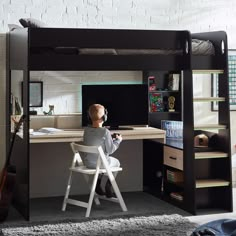 a child sitting at a desk in front of a bunk bed