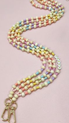 a multi - colored beaded necklace with a pair of scissors hanging from it's end