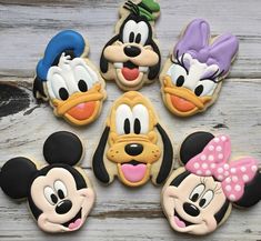 mickey and minnie mouse cookies on a table