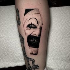 a person with a creepy face on their leg