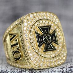 a gold ring with an emblem on it