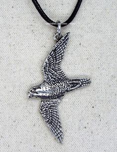 a silver bird on a black cord necklace