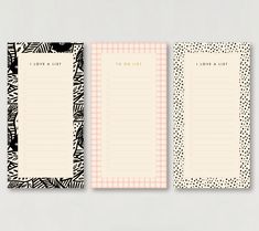 two blank notepads with black and white designs on them, one has a pink checkered border