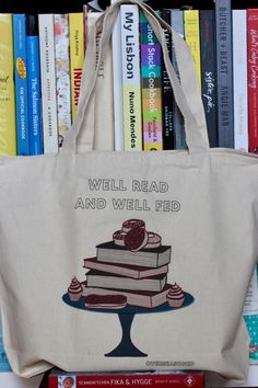 a tote bag sitting on top of a bookshelf filled with lots of books