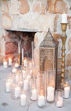 the website for moroccan wedding inspiration is displayed with candles and an ornate lantern in front of a stone fireplace