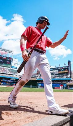 a man holding a baseball bat on top of a field