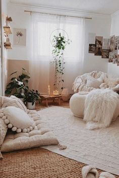 a living room filled with lots of white furniture and pillows on top of a rug