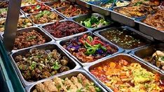 many trays of food that are on display