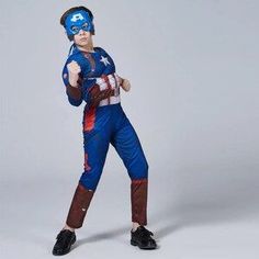 a young boy dressed as captain america is posing for the camera with his hands on his hips