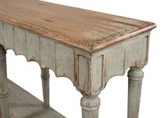 an old wooden table with two legs and a shelf on the bottom is painted white