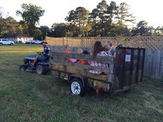 children are riding in the back of a trailer