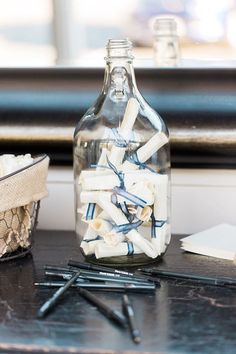 a glass bottle filled with lots of white matches