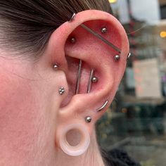 a woman with three piercings on her ear