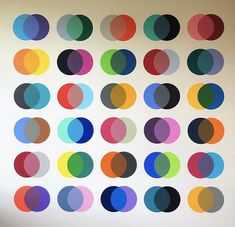 a wall with many different colored circles on it