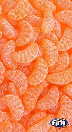 orange candy hearts are shown in this close up photo, with the word's logo on