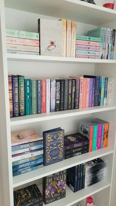 a white book shelf filled with lots of books