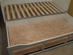 a bed with wooden slats on top of it and no mattresses in the bottom