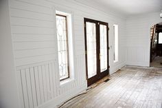 an empty room with wood flooring and white paint on the walls is being remodeled