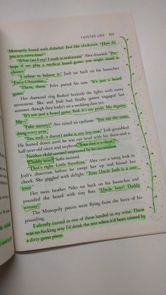 an open book with green writing on the page and inside pages that have been turned upside down