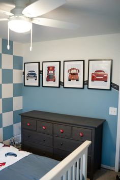 a baby's room with three pictures on the wall and a dresser in front of it