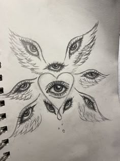 a drawing of an owl's face with eyes and feathers on it, in the shape of a heart