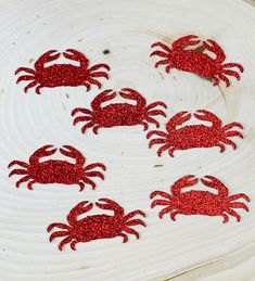 there are red crabs on the white plate