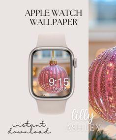 the apple watch wallpaper is pink and has an ornament hanging from it