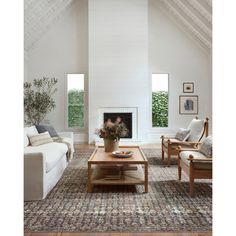 a living room filled with furniture and a fire place in the middle of a room