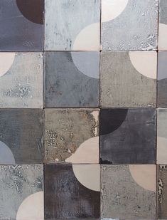 an abstract painting made up of squares and circles in grey, brown, white and black