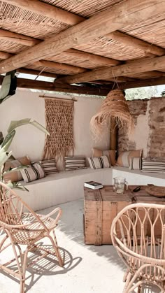 an outdoor living area with wicker furniture