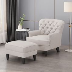 a white chair and ottoman in a room