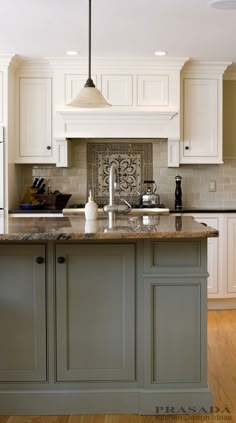 a large kitchen with white cabinets and marble counter tops, along with an island in the middle