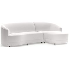 a curved white couch sitting on top of a white floor