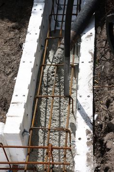 pipes are connected to the foundation of a building