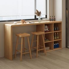 two wooden stools sitting next to a bar