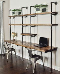 a laptop computer sitting on top of a wooden desk in front of a wall mounted shelving unit