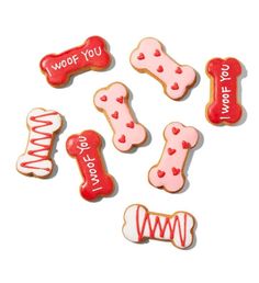 some cookies that are shaped like dogs and bones with words written on the top one