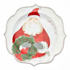 a santa clause holding a wreath on a white plate