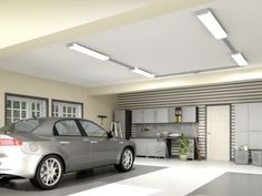 a car is parked in a garage next to a wall mounted oven and refrigerators