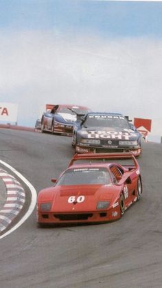 two racing cars driving on a race track