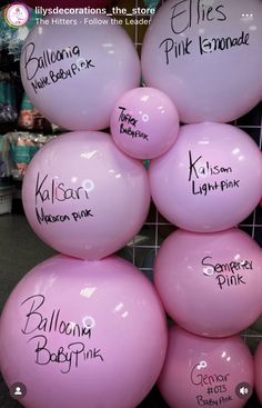 pink balloons with names on them in a store