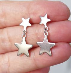 Silver Star Charm Earrings In Stainless Steel, Silver Stainless Steel Star Charm Earrings, Silver Stainless Steel Earrings With Star Charm, Hypoallergenic Star-shaped Metal Earrings, Star-shaped Stainless Steel Earrings For Gifts, Stainless Steel Star Earrings For Gifts, Star Shaped Stainless Steel Earrings For Gifts, Stainless Steel Star Charm Earrings For Gift, Stainless Steel Star Charm Earrings Gift