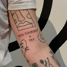 a person with a tattoo on their arm that says give yourself a try