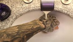 a person's arm is being washed in a sink