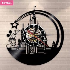 a clock with mickey mouse on it in front of a brick wall