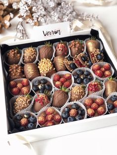 a box filled with lots of chocolate covered strawberries and berries on top of each other