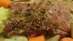 a plate with meat, vegetables and seasoning on it sitting on top of a table