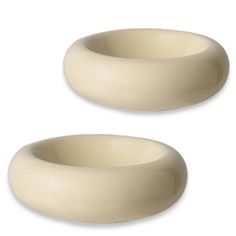 two white bowls sitting next to each other