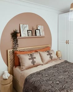 a bedroom with a bed, nightstands and pictures on the wall above it's headboard