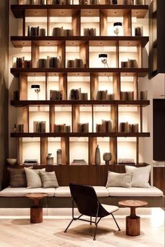 a living room filled with lots of bookshelves next to a couch and coffee table